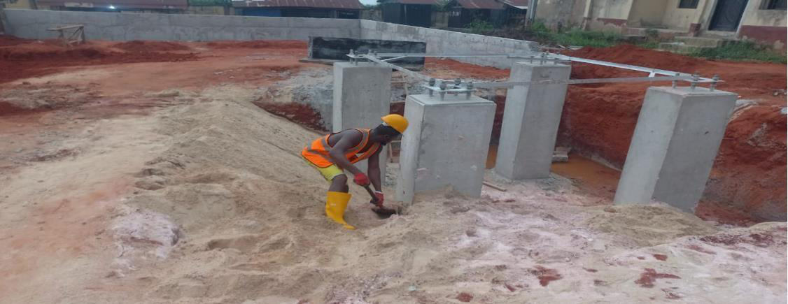 Backfilling around tower foundations.